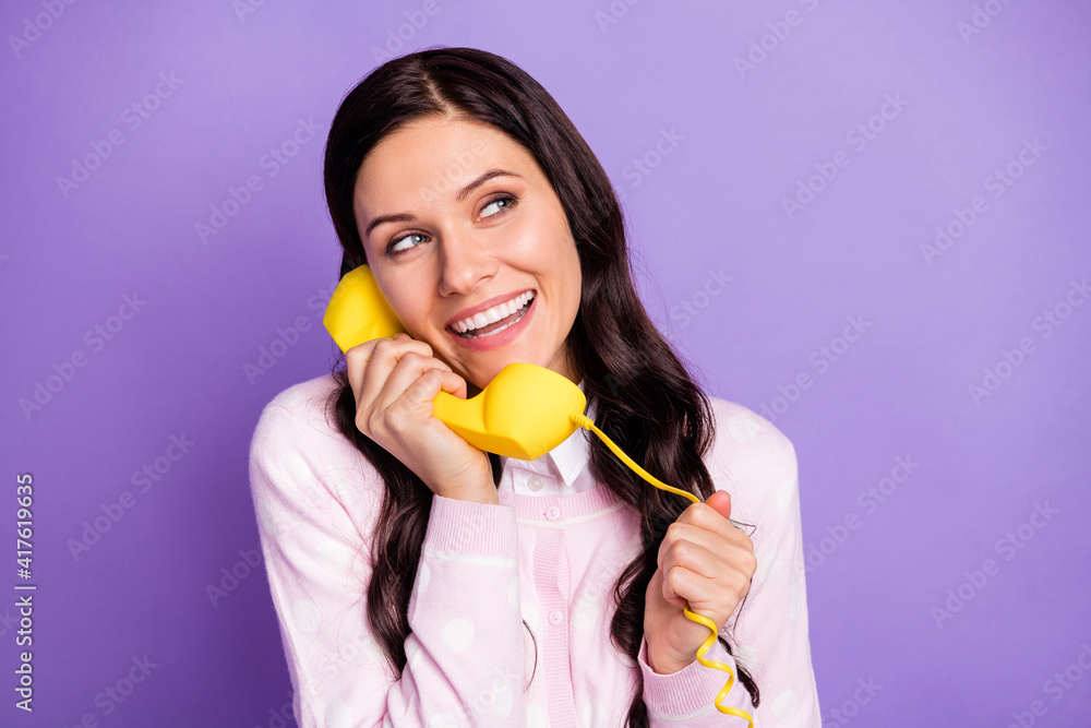 Portrait of lovely cheerful wavy-haired girl calling friend discussing gossip isolated over violet color background Portrait of lovely cheerful wavy-haired girl calling friend discussing gossip isolated over violet color background