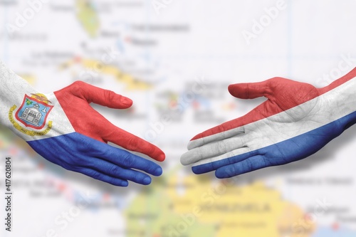 Sint Maarten and the Netherlands - Flag handshake symbolizing partnership and cooperation