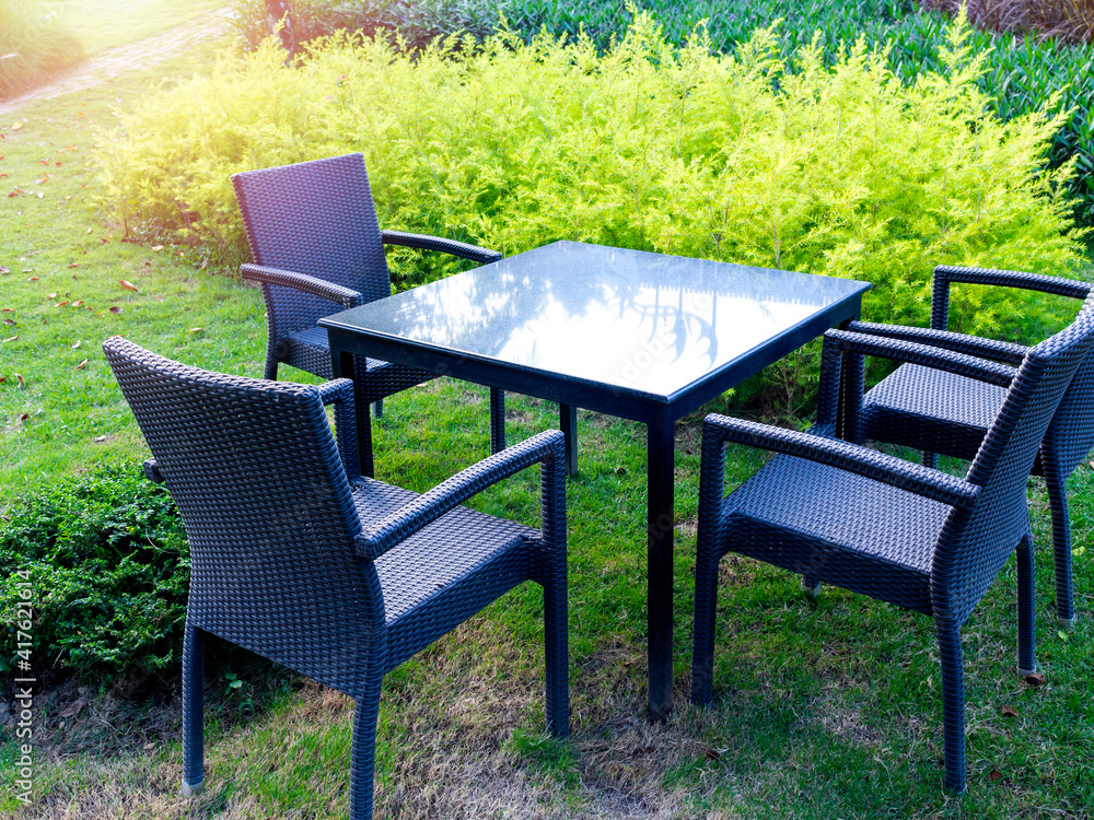 Table set with modern rattan chairs and glass dining table.