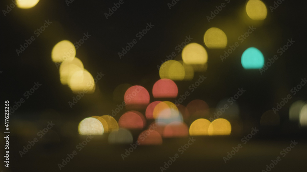 Fototapeta premium Abstract background of city lights bokeh. Blurred city lights . Defocused blurred lights. City at night . Traffic light. Traffic light bokeh. City bokeh night light .