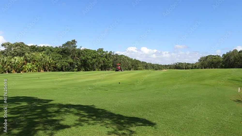 Mower grass equipment working on a summer day. Lawn mowing, Mexico. Gardener cuts green grass on the perfect golf course. Mower grass equipment working on a summer day. Lawn mowing, Mexico. Gardener cuts green grass on the perfect golf course.