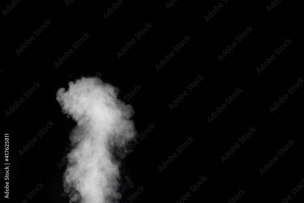 White vapor spray steam from air saturator. Smoke fragments on a black background. Abstract background, design element, for overlay on pictures White vapor spray steam from air saturator. Smoke fragments on a black background. Abstract background, design element, for overlay on pictures