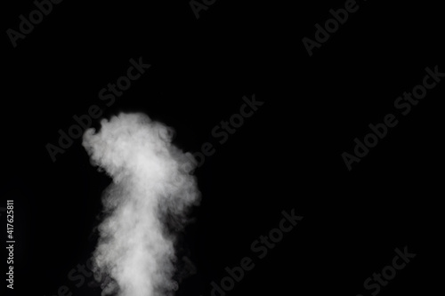White vapor spray steam from air saturator. Smoke fragments on a black background. Abstract background, design element, for overlay on pictures