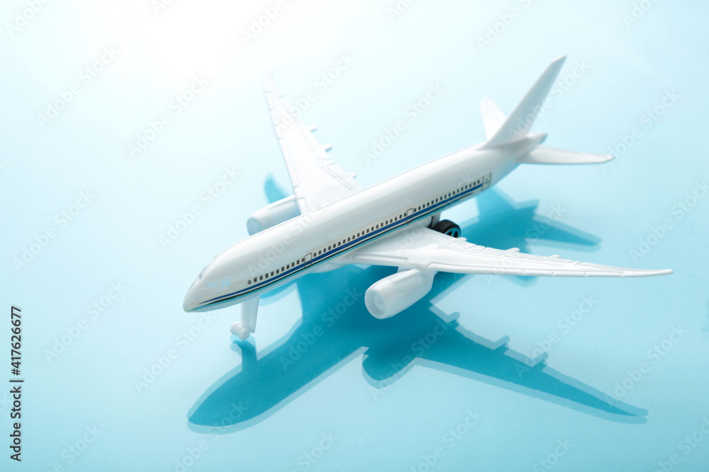 Model airplane with shadow on blue pastel color background. Model airplane with shadow on blue pastel color background.