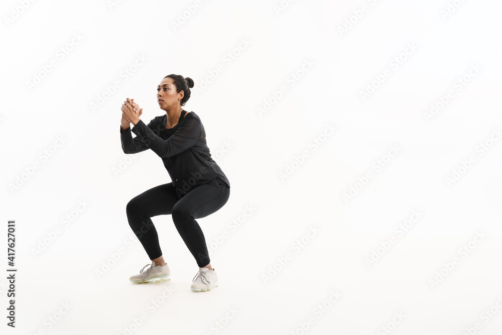 Focused african american woman doing exercise while working out Focused african american woman doing exercise while working out