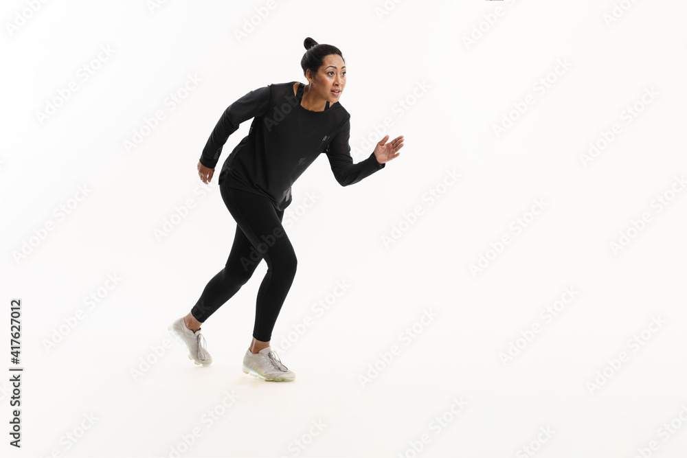 Focused african american woman running while working out