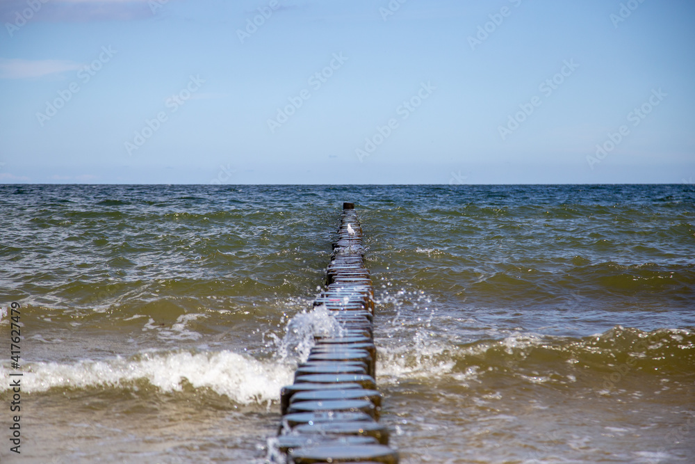 Breaking waves on the wooden planks at the Baltic Sea.. Breaking waves on the wooden planks at the Baltic Sea..