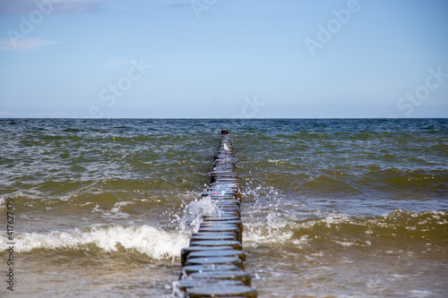 Breaking waves on the wooden planks at the Baltic Sea..