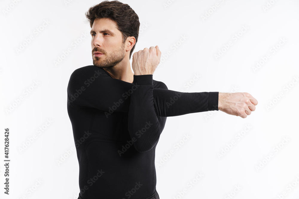 Young athletic sportsman doing exercise while working out Young athletic sportsman doing exercise while working out