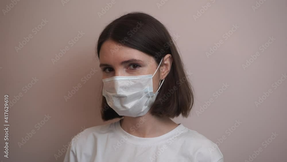 Girl Puts on Medical Mask. Health Protection Corona Virus Concept. 4K Girl Puts on Medical Mask. Health Protection Corona Virus Concept. 4K
