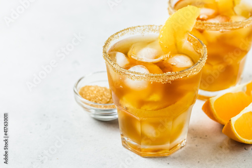 Vanilla orange iced summer mocktail in glasses. Space for text.