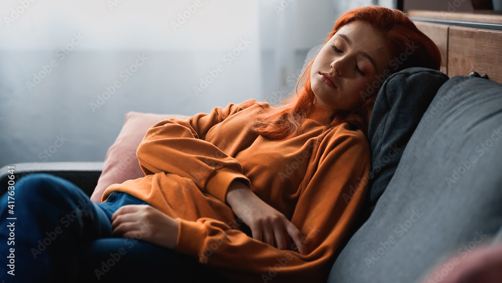 Teen girl sleeping on couch in living room Teen girl sleeping on couch in living room