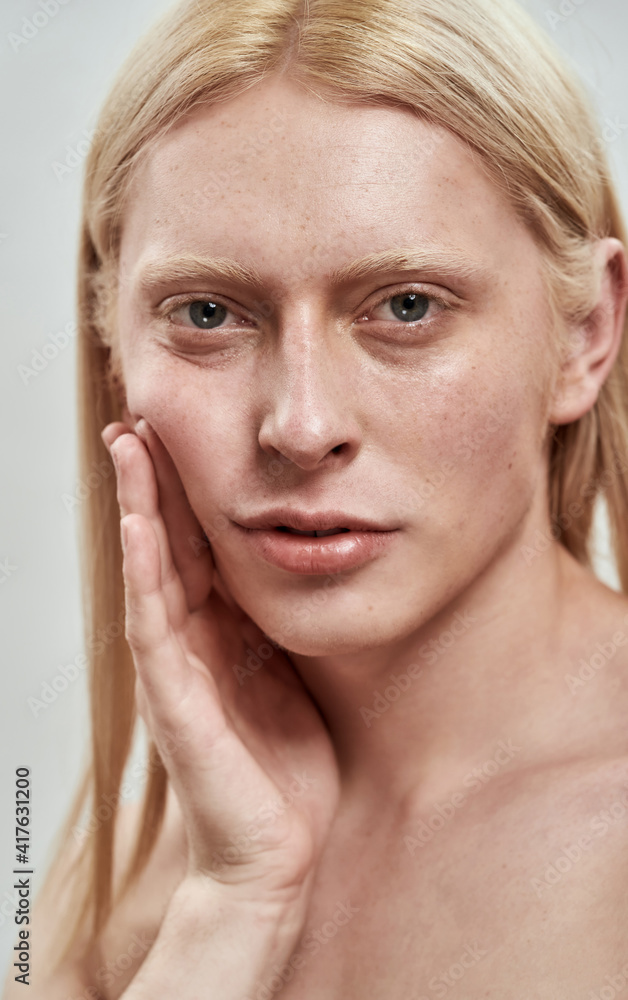 Portrait of handsome young caucasian man tightening cheek Portrait of handsome young caucasian man tightening cheek