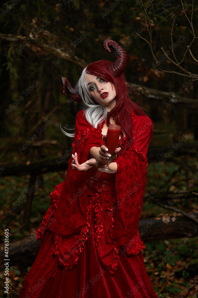 Stylish and fashionable model girl in the image of Maleficent posing among mystic forest - fairytale story, cosplay. Halloween Stylish and fashionable model girl in the image of Maleficent posing among mystic forest - fairytale story, cosplay. Halloween