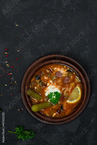 a national dish of Russian and Ukrainian cuisine. meat soup with pickles, olives, onions and lemon. with sour cream 