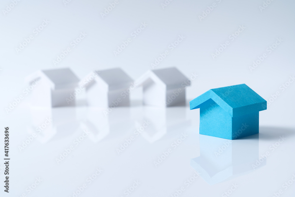 Blue house in among white houses for real estate property industry Blue house in among white houses for real estate property industry