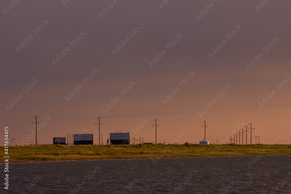 Wooden houses and Kazakh yurt at the lake Saryoba in Kazakhstan steppe. Wooden houses and Kazakh yurt at the lake Saryoba in Kazakhstan steppe.