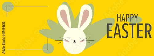 bright yellow greeting Easter card and white rabbit, green plants and place for an inscription