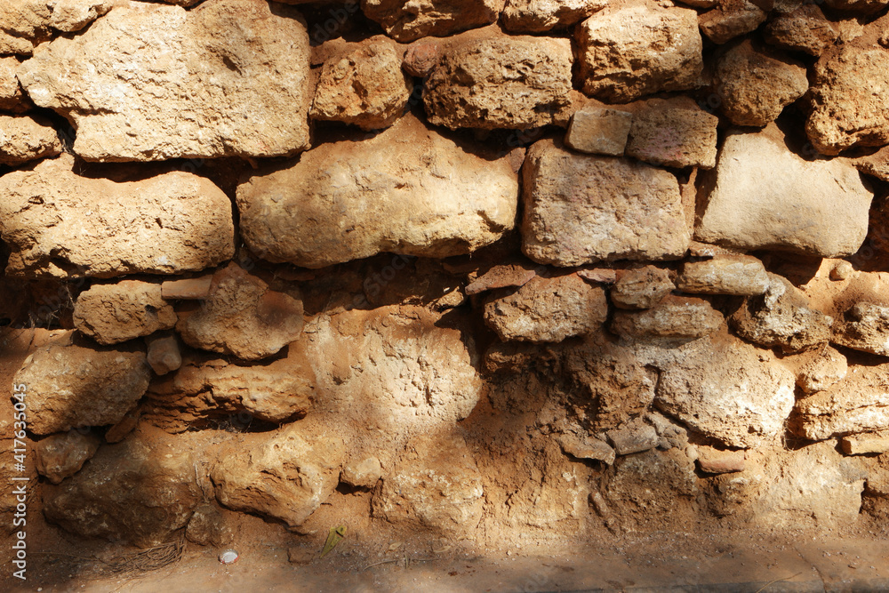 Fototapeta premium Texture of old stone wall surface. Ancient stone wall structure. Rock wall background.