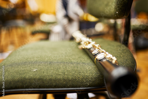 Fototapeta Naklejka Na Ścianę i Meble -  A close-up of a wooden instrument - oboe, lying on a chair.