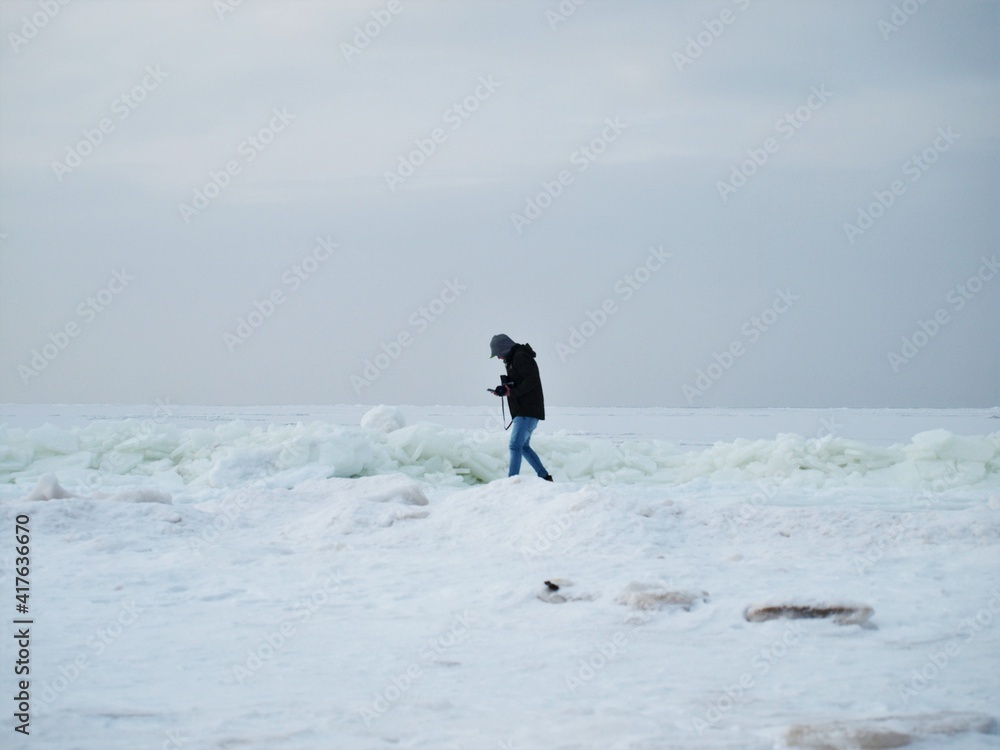 At the beach during winter by the frozen sea. At the beach during winter by the frozen sea.
