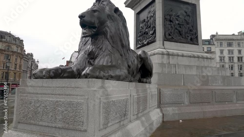 Slow motion shot showing in detail the famous, iconic, lion statue from Trafalgar Square, London photo