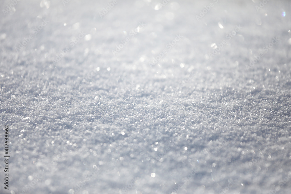 Snow close-up, winter background with copy space, glittering snowflakes.