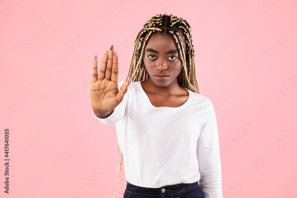 Portrait of a serious black woman showing stop gesture Portrait of a serious black woman showing stop gesture