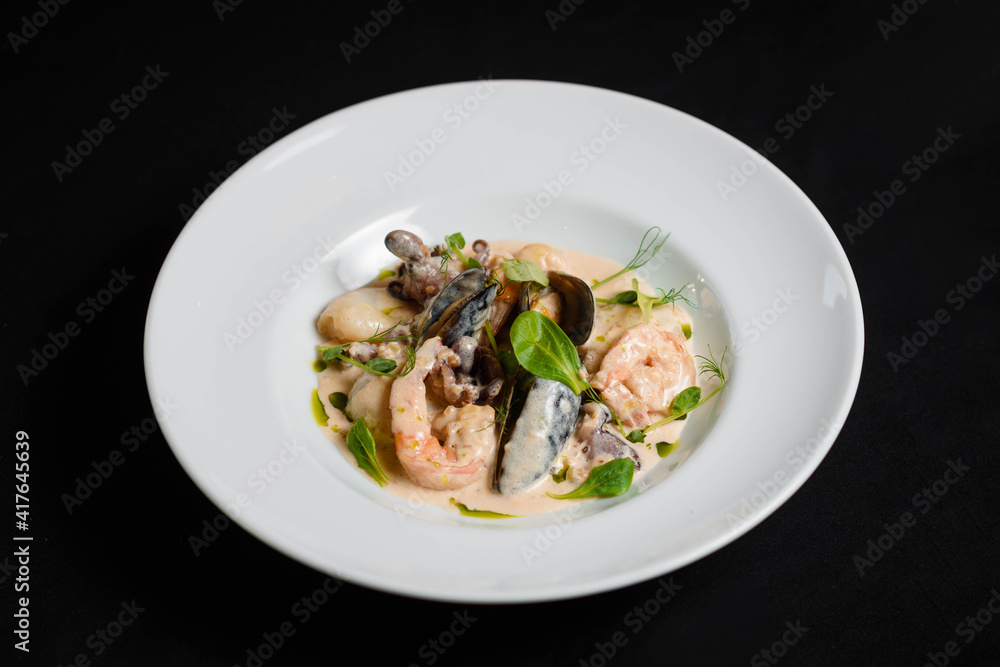 Shrimp and mussels platter in sauce on the white plate