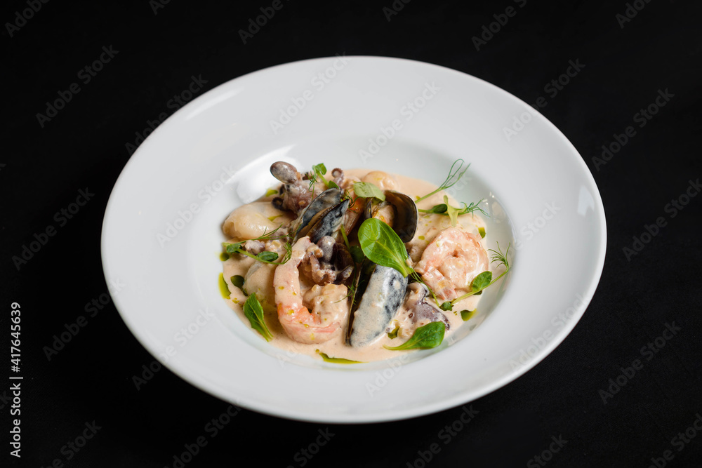 Shrimp and mussels platter in sauce on the white plate Shrimp and mussels platter in sauce on the white plate