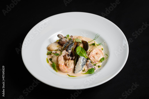 Shrimp and mussels platter in sauce on the white plate