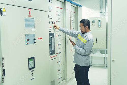 the technician and engineerin preventive maintenance checking of power system of industry