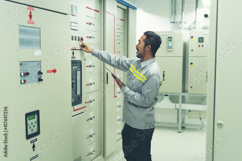 the technician and engineerin preventive maintenance checking of power system of industry photo