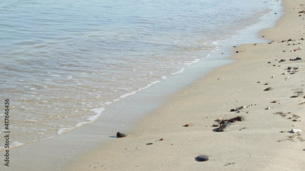 Calm waves of the sea beat on the shore on a sunny day Calm waves of the sea beat on the shore on a sunny day
