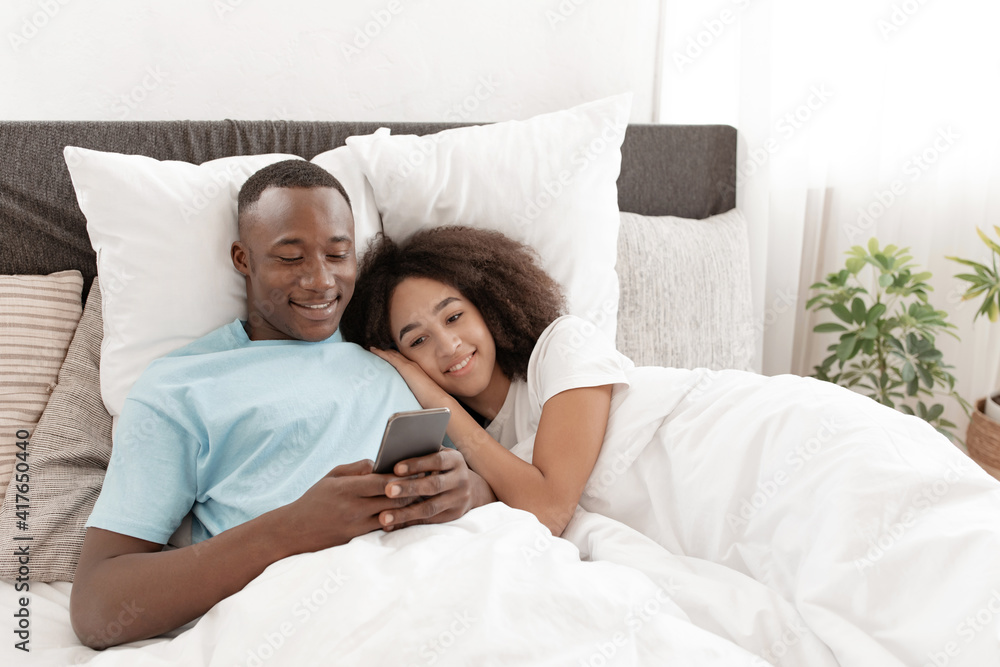 Fototapeta premium Relax and rest at home together in bed, weekend and free time