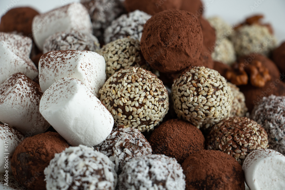 truffles with cocoa, coconut and sesame seeds with chocolate and marshmallows, delicious dessert truffles with cocoa, coconut and sesame seeds with chocolate and marshmallows, delicious dessert