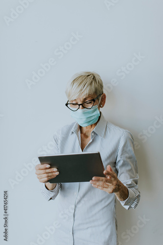 Mature businesswoman using ...