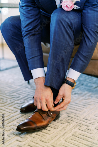 businessman tying shoes