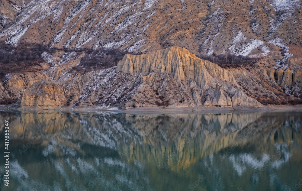 Erzurum, Tortum lake, cliff mountains and cloud reflection in water. January 2021 Erzurum, Tortum lake, cliff mountains and cloud reflection in water. January 2021