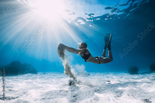 Free diver with fins and white sand in hands over sandy sea. Freediving in tropical ocean © artifirsov