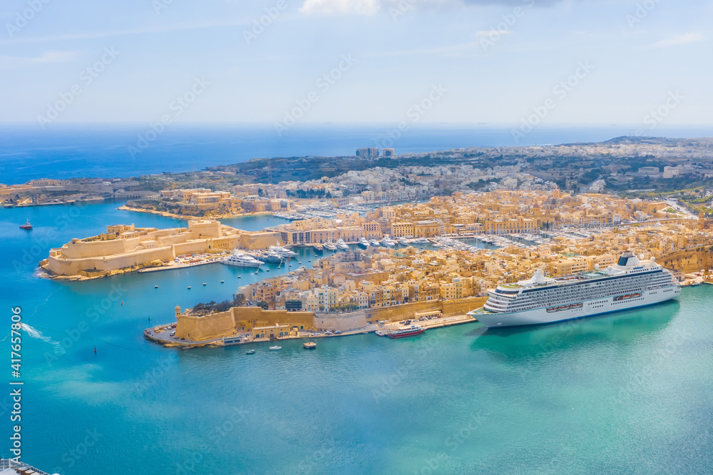 Aerial height view of Malta Valletta and Birgu, floating sailing passanger cruise liner ship to the Great Bay.