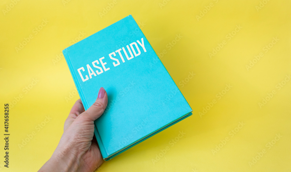 Case Study text on a green notebook in a female hand on a white background. Case Study text on a green notebook in a female hand on a white background.