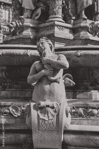 statue of a woman holding a fish