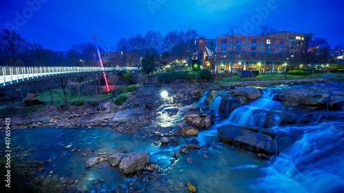 Night time-lapse view of Liberty Bridge at Falls Park on the Reedy in Greenville, SC, United States of America