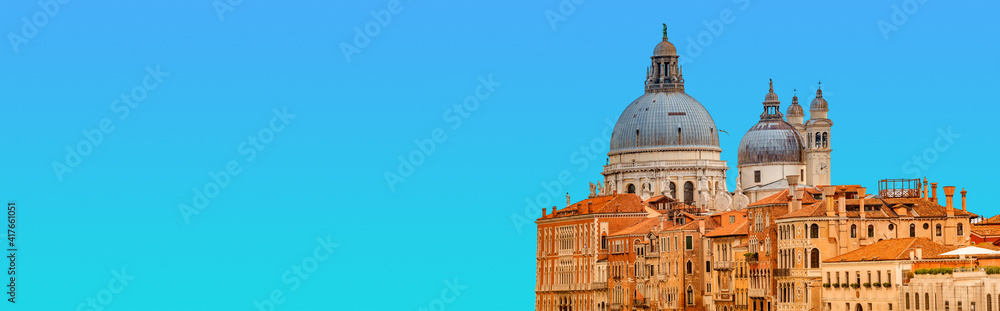 Banner with Basilica di Santa Maria della Salute at beautiful calm sunset and blue sky with copy space for text, Venice, Italy. Concept of religion and historical heritage.
