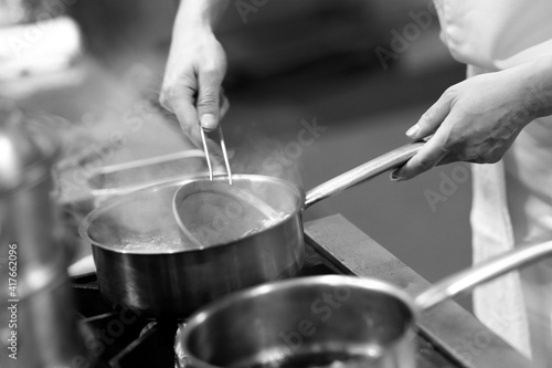 Chef cooking in a kitchen, chef at work, Black and White.