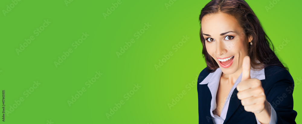 Businesswoman in confident black suit, showing thumbs up gesture, copy space place for some text, advertising or slogan, over green color background. Business concept photo. Businesswoman in confident black suit, showing thumbs up gesture, copy space place for some text, advertising or slogan, over green color background. Business concept photo.