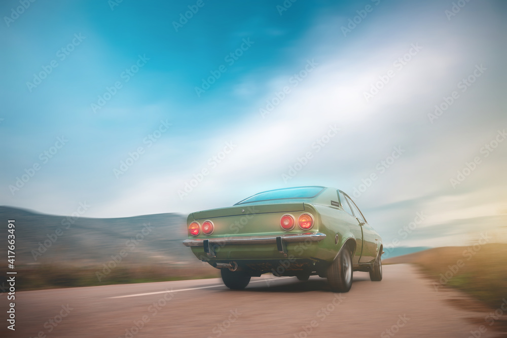 Fototapeta premium Vintage green car on the road