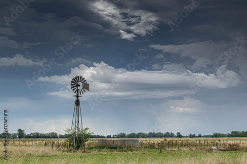 Windmill and a stormy sky in a rural environment
