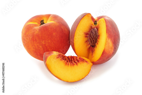 Whole peach and cut peach with slice isolated on white